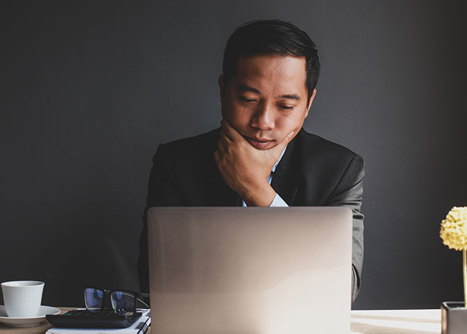 man looking at laptop screen