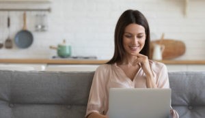 woman looking down at laptop