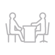 Student and professor sitting at a desk icon