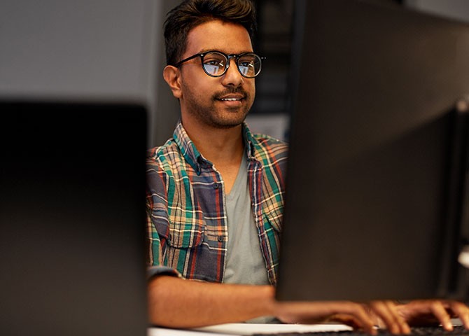 man typing on computer