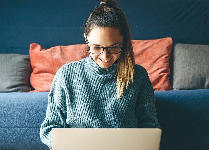 woman looking down at laptop