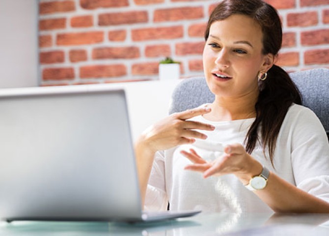 woman talking on laptop