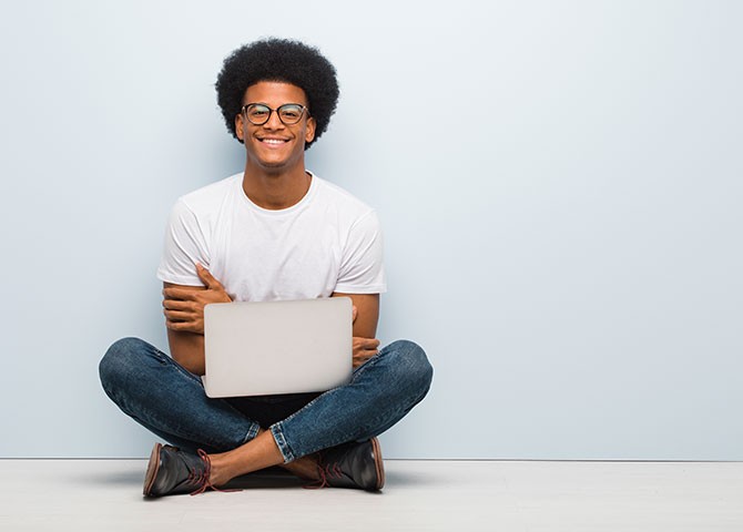 man sitting on floor with laptop