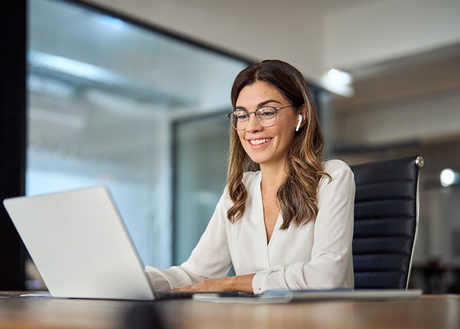 Woman working on a computer for talent acquisition