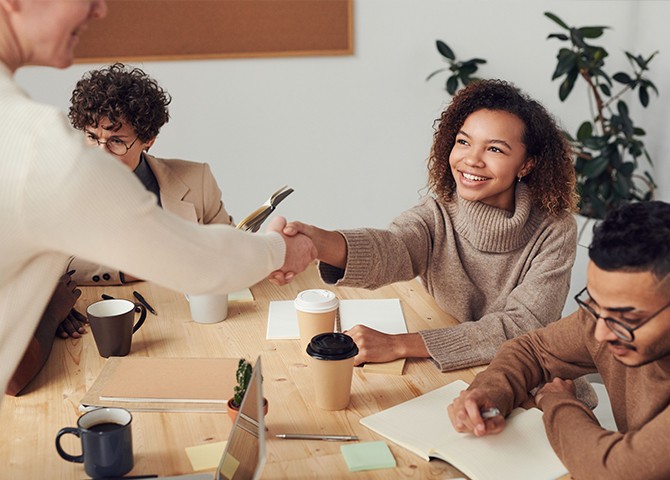 Hiring team and candidate meeting around a table during a job interview